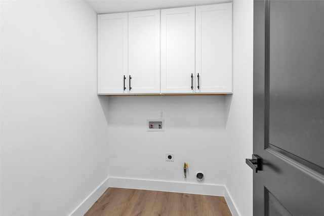 laundry area with cabinets, hookup for a washing machine, gas dryer hookup, electric dryer hookup, and light hardwood / wood-style flooring