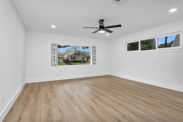 empty room with light hardwood / wood-style flooring and ceiling fan