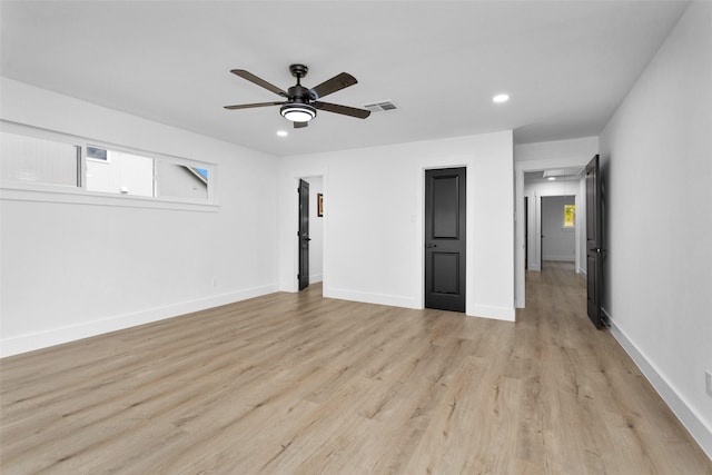 unfurnished bedroom with ceiling fan and light hardwood / wood-style flooring