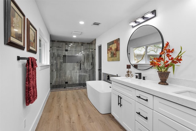 bathroom with separate shower and tub, vanity, and wood-type flooring