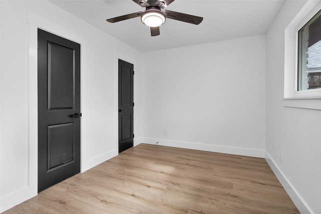 spare room featuring ceiling fan and light hardwood / wood-style floors