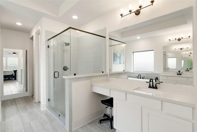 bathroom with vanity, ceiling fan, and walk in shower