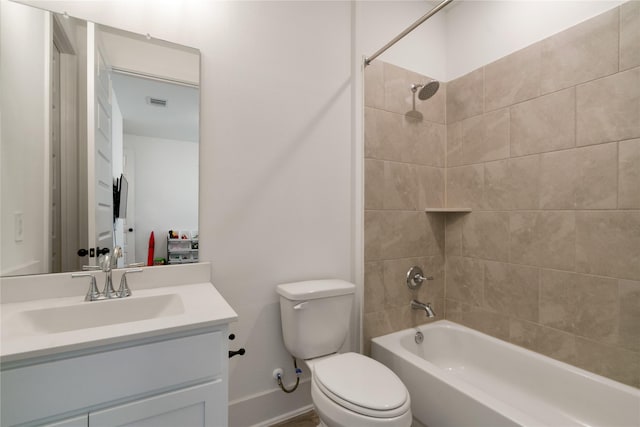 full bathroom with vanity, tiled shower / bath combo, and toilet