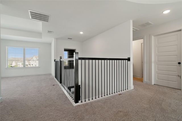 hallway with carpet, visible vents, and recessed lighting