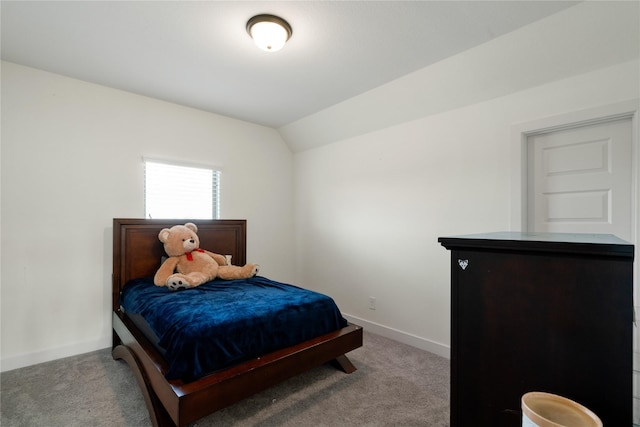 bedroom with light carpet, baseboards, and lofted ceiling