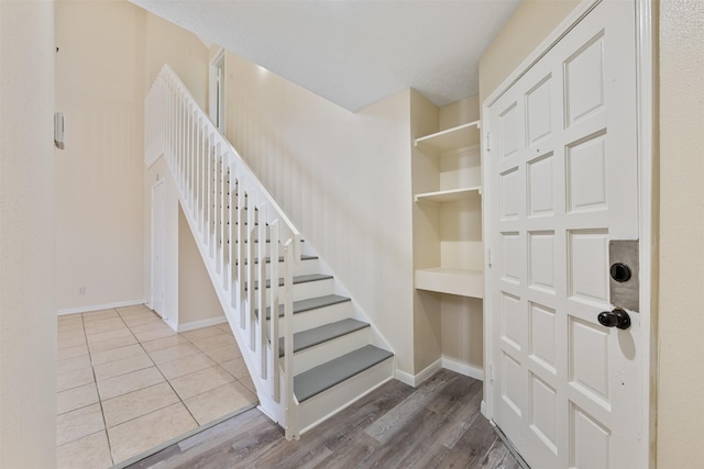 stairway with hardwood / wood-style floors