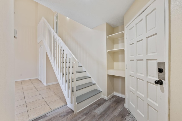 12406 S Rylander Cir, Houston, TX 77071 - stairway featuring baseboards and wood finished floors