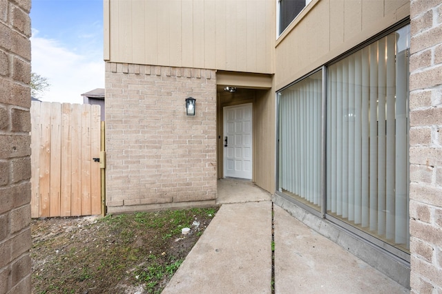 12406 S Rylander Cir, Houston, TX 77071 - property entrance featuring brick siding, a gate, and fence