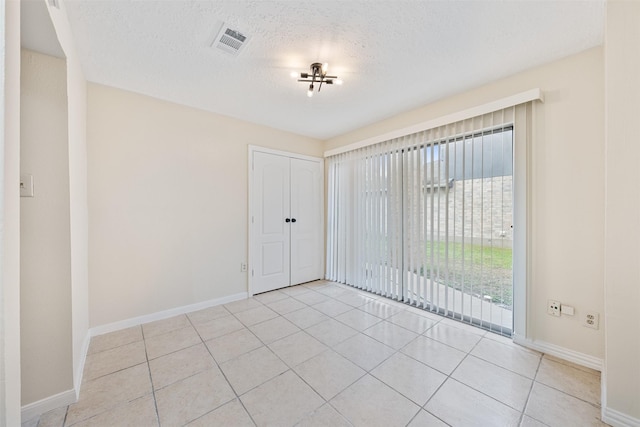 12406 S Rylander Cir, Houston, TX 77071 - empty room featuring baseboards, a textured ceiling, and light tile patterned floors