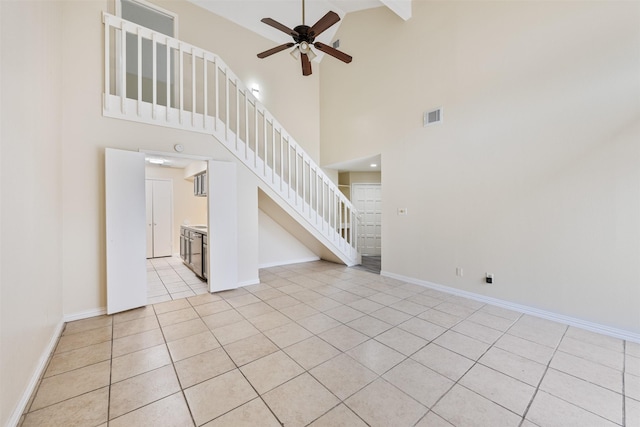 12406 S Rylander Cir, Houston, TX 77071 - unfurnished living room with ceiling fan, light tile patterned floors, high vaulted ceiling, stairs, and baseboards