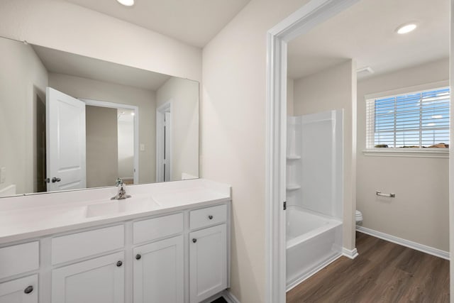 full bathroom featuring vanity, hardwood / wood-style flooring, toilet, and  shower combination