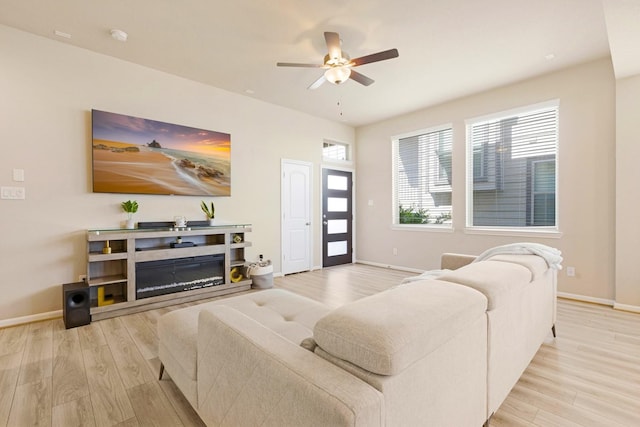 living room with light hardwood / wood-style floors and ceiling fan