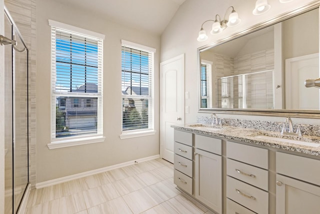 bathroom featuring lofted ceiling, an enclosed shower, and vanity