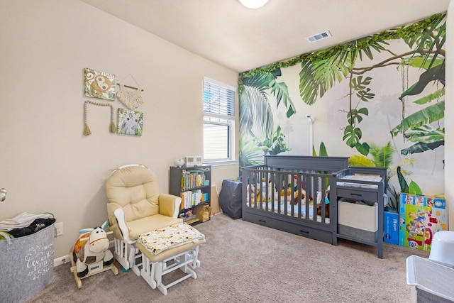 bedroom featuring a crib and carpet flooring