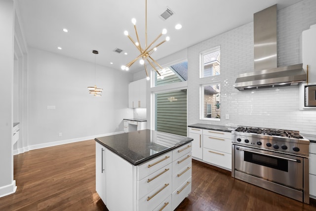 kitchen featuring wall chimney range hood, high end stainless steel range oven, hanging light fixtures, dark hardwood / wood-style floors, and white cabinetry