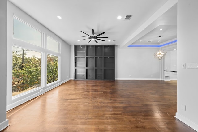 unfurnished living room featuring dark hardwood / wood-style floors and ceiling fan