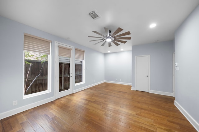 spare room with hardwood / wood-style flooring and ceiling fan