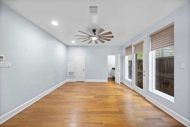 empty room with ceiling fan and light hardwood / wood-style flooring