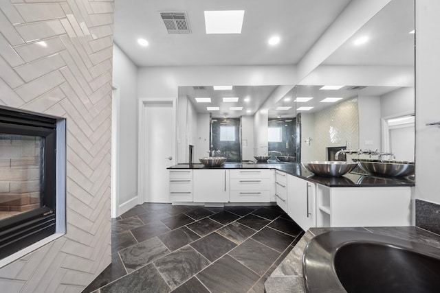 bathroom featuring vanity and a skylight