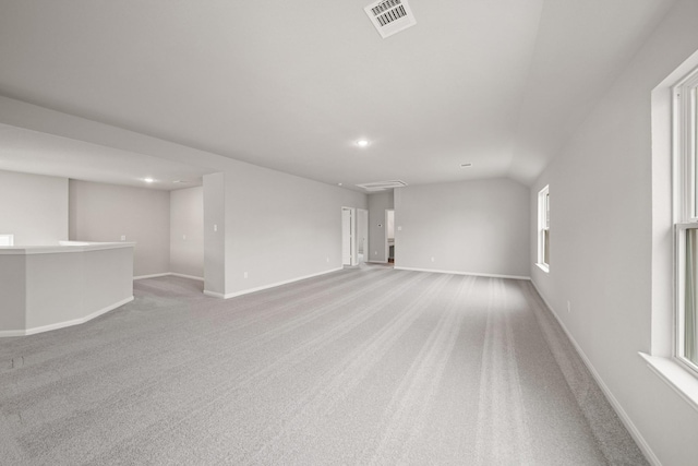 carpeted spare room with visible vents and baseboards