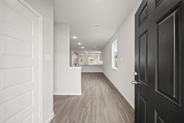 foyer entrance featuring recessed lighting, wood finished floors, visible vents, and baseboards