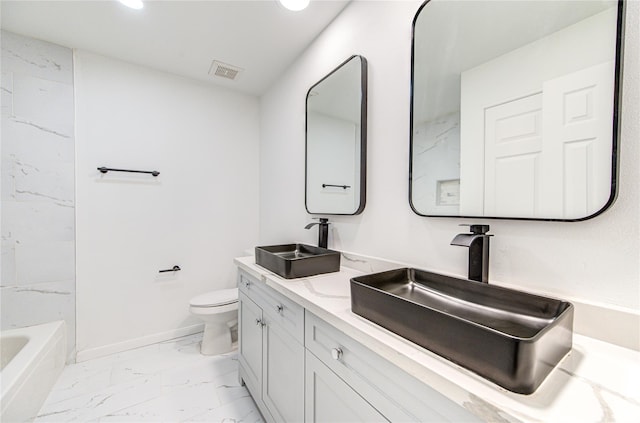 full bathroom with vanity, toilet, and tiled shower / bath