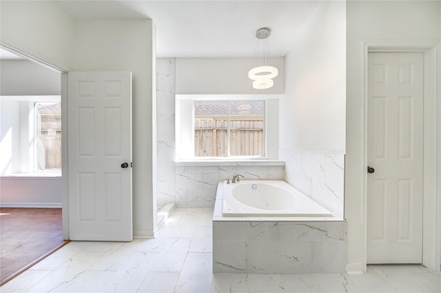 bathroom with a relaxing tiled tub and tile walls