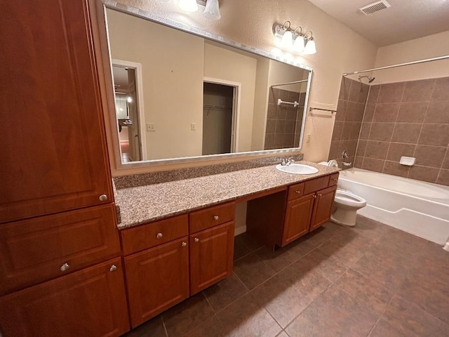 full bathroom featuring tile patterned floors, vanity, toilet, and tiled shower / bath