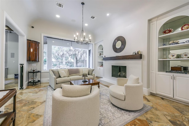 living room with a notable chandelier and built in shelves