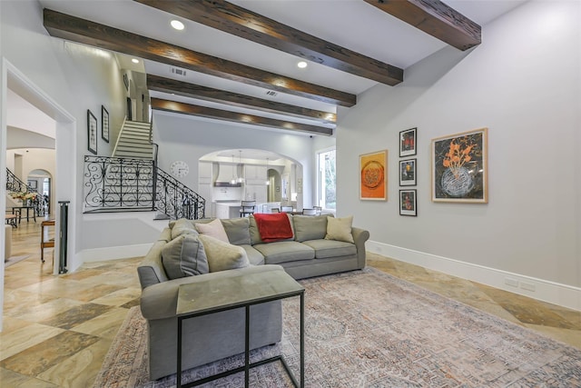 living room featuring beamed ceiling