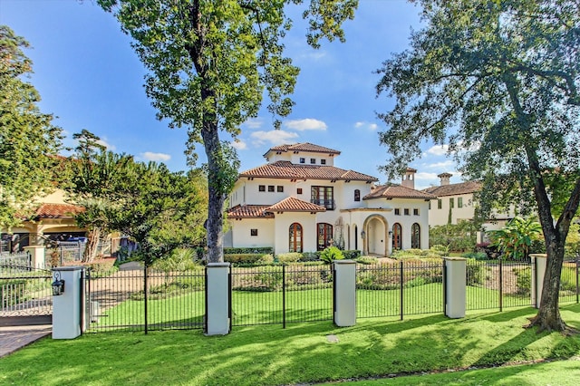 mediterranean / spanish-style house with a front yard