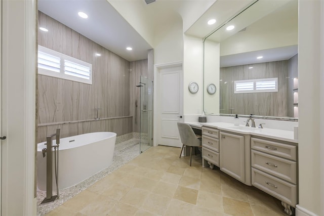 bathroom with plus walk in shower, vanity, vaulted ceiling, and a wealth of natural light