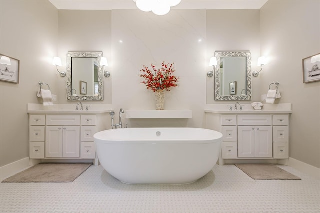 bathroom featuring tile patterned floors, a bathing tub, and vanity