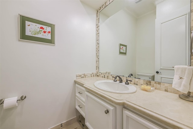 bathroom with tile patterned floors, vanity, ornamental molding, and toilet