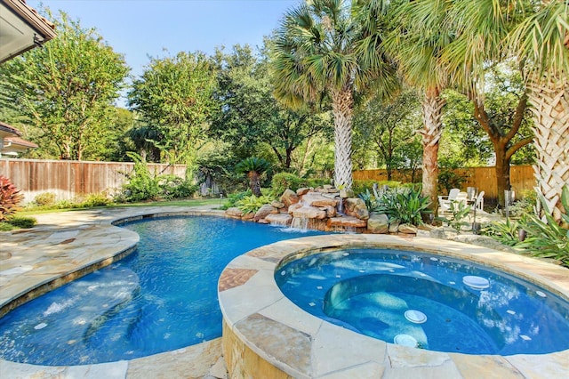 view of pool with an in ground hot tub