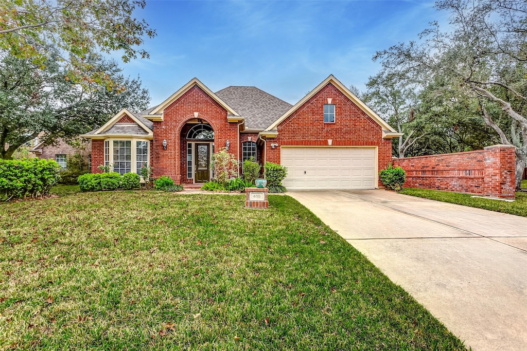 front of property featuring a garage and a front lawn