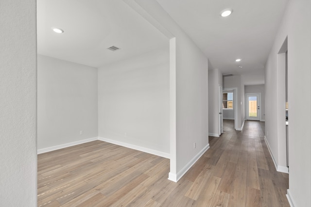 corridor with light hardwood / wood-style floors