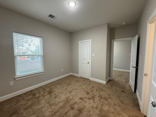 unfurnished bedroom with carpet floors