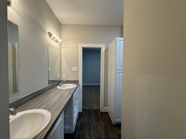 bathroom with hardwood / wood-style flooring and vanity