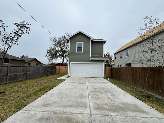 rear view of property with a garage and a lawn