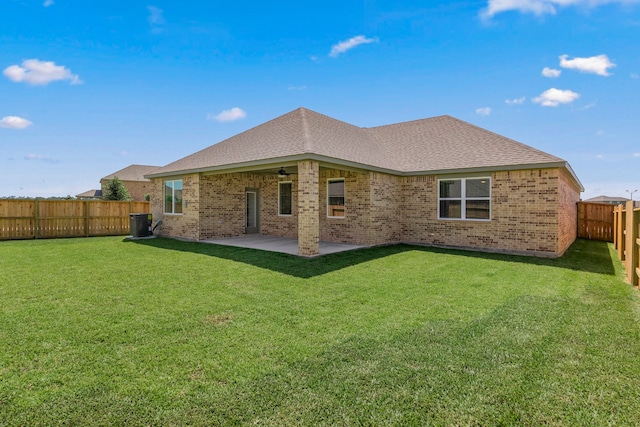 rear view of property featuring central AC unit, ceiling fan, a patio area, and a yard