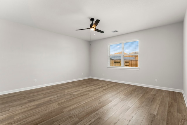 unfurnished room with ceiling fan and wood-type flooring