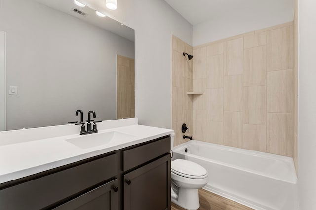 full bathroom with wood-type flooring, vanity, toilet, and tiled shower / bath