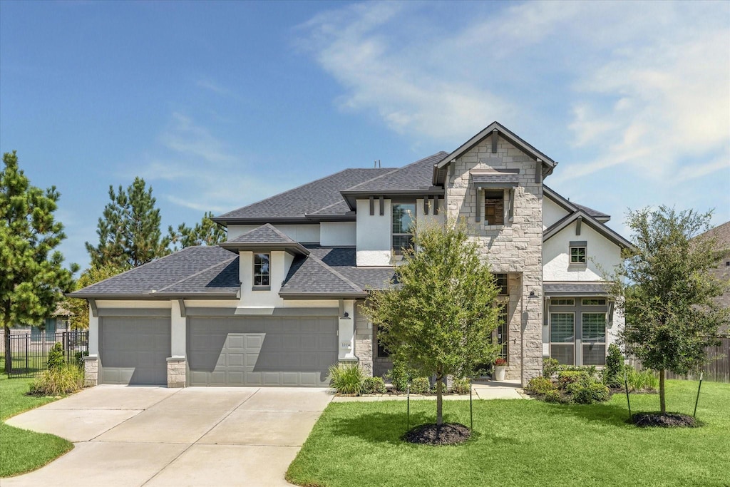 view of front of property with a garage and a front lawn