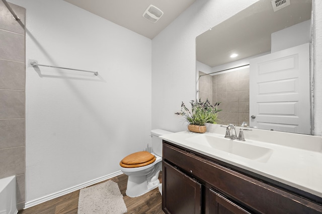 bathroom featuring hardwood / wood-style floors, vanity, and toilet