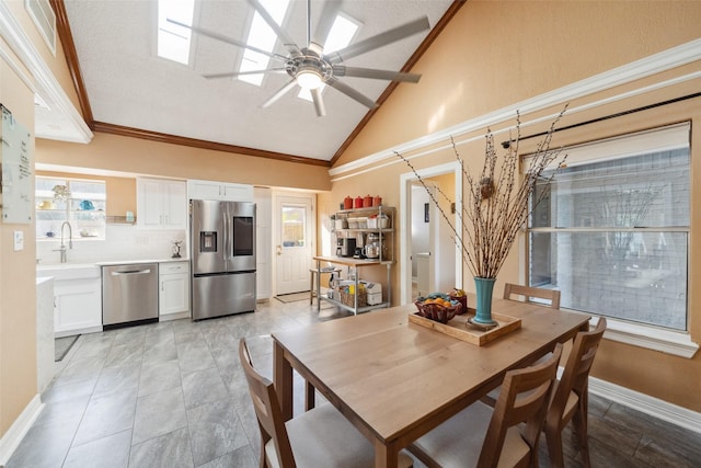 dining space featuring lofted ceiling, ceiling fan, ornamental molding, and baseboards