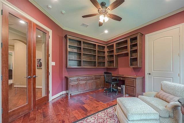 office space with french doors, ceiling fan, crown molding, built in desk, and dark hardwood / wood-style floors