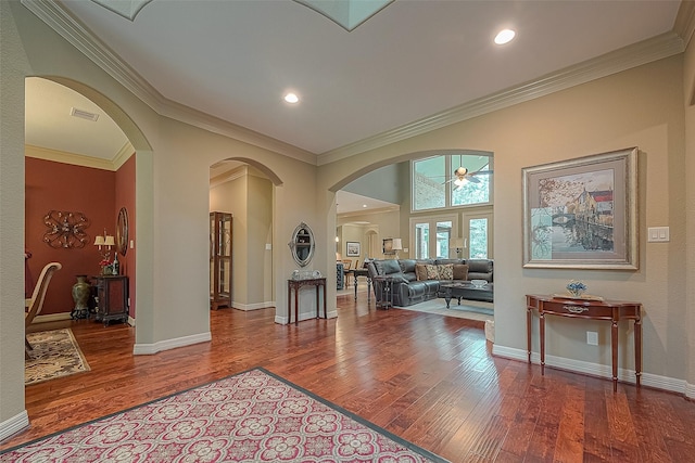 foyer with ceiling fan, french doors, wood-type flooring, and ornamental molding