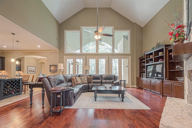 living room featuring ceiling fan, dark hardwood / wood-style flooring, and high vaulted ceiling