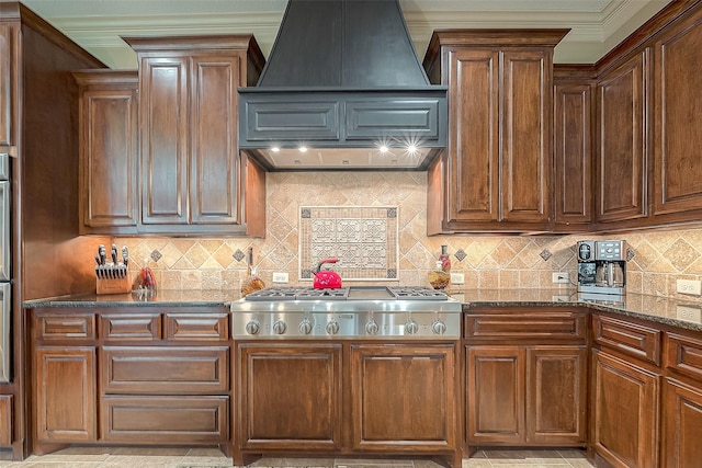 kitchen with custom exhaust hood, decorative backsplash, crown molding, and stainless steel gas cooktop